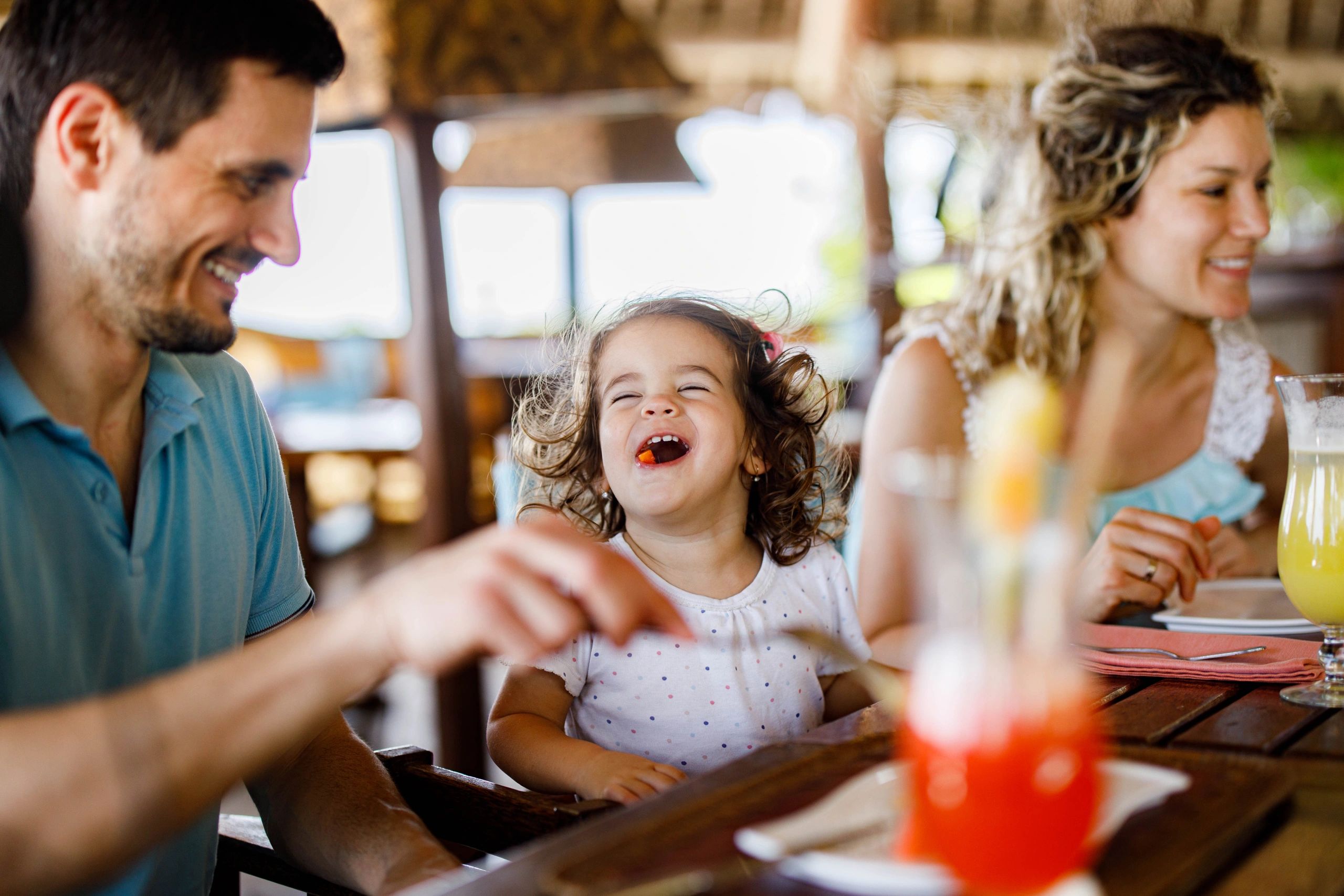 Family enjoying a meal together at a restaurant table